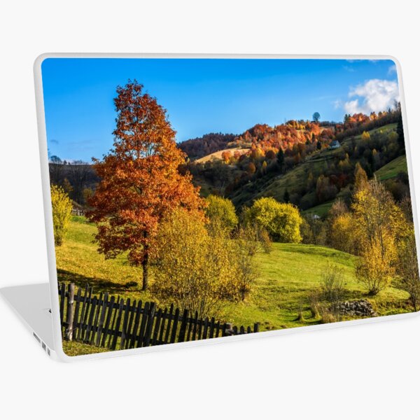 red tree behind the fence on hillside Laptop Skin