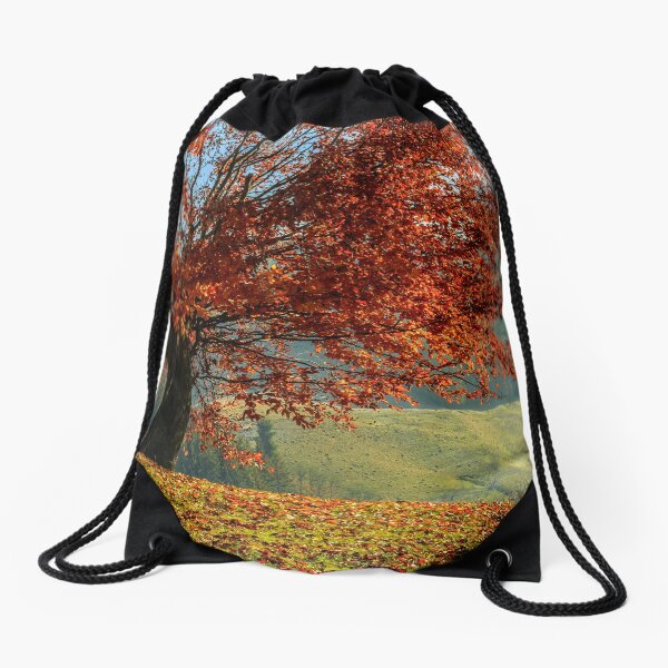 red tree in front of spruce forest in fog Drawstring Bag