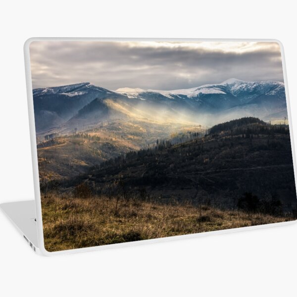 snowy peaks over hillsides in fog Laptop Skin