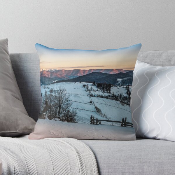 fence on snowy mountain slope near the forest in winter Throw Pillow