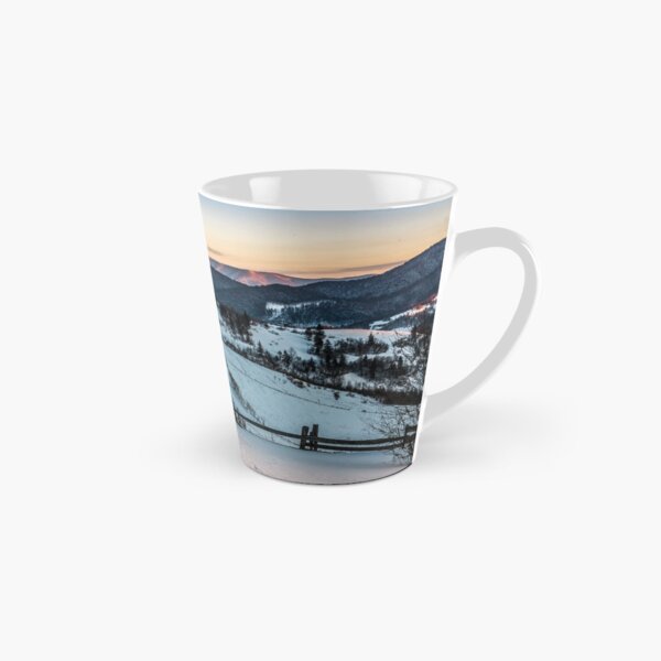 fence on snowy mountain slope near the forest in winter Tall Mug