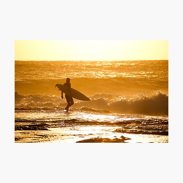 Surfer walking into the waves at sunset, Western-Australia Photographic Print