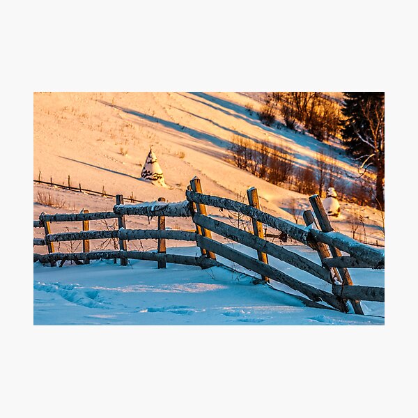 fence on snowy mountain slope near the forest in winter Photographic Print