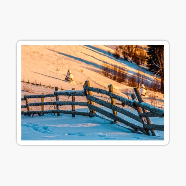 fence on snowy mountain slope near the forest in winter Sticker