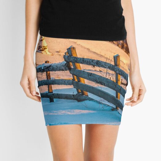 fence on snowy mountain slope near the forest in winter Mini Skirt