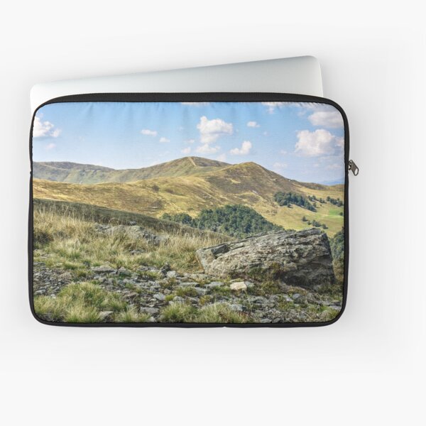 mountain landscape with stones in the grass on hillside and blue sky Laptop Sleeve