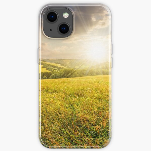 rural field near forest at hillside at sunset iPhone Soft Case