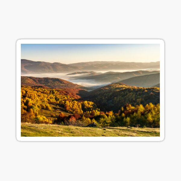 cold fog on hot sunrise in mountains Sticker