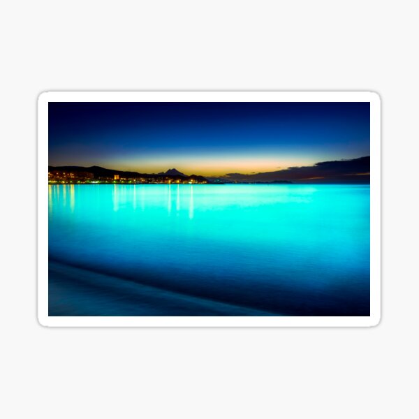 The sea glowed turquoise Sticker
