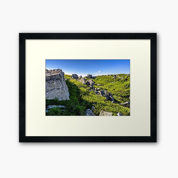 huge stones in valley on top of mountain range at sunrise Framed Art Print