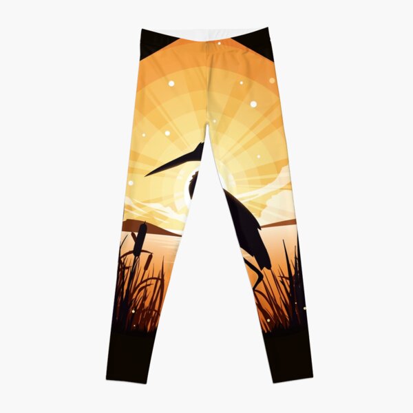 The heron stands on the shore of the lake Leggings