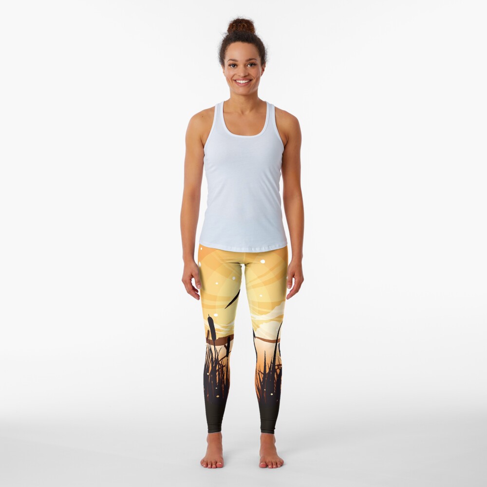 The heron stands on the shore of the lake Leggings