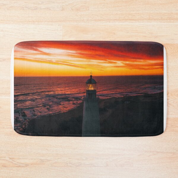 Item preview, Lighthouse On A Sunset Lit Shore designed and sold by Taceo10.
