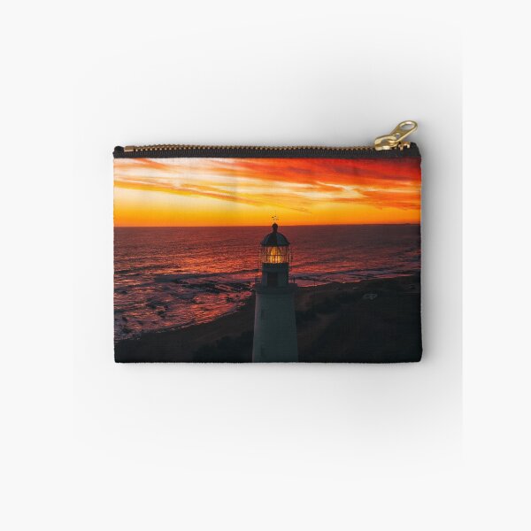 Item preview, Lighthouse On A Sunset Lit Shore designed and sold by Taceo10.