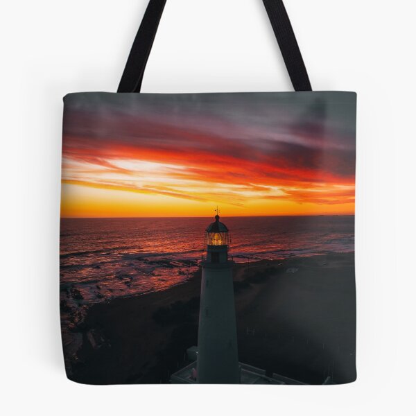 Item preview, Lighthouse On A Sunset Lit Shore designed and sold by Taceo10.