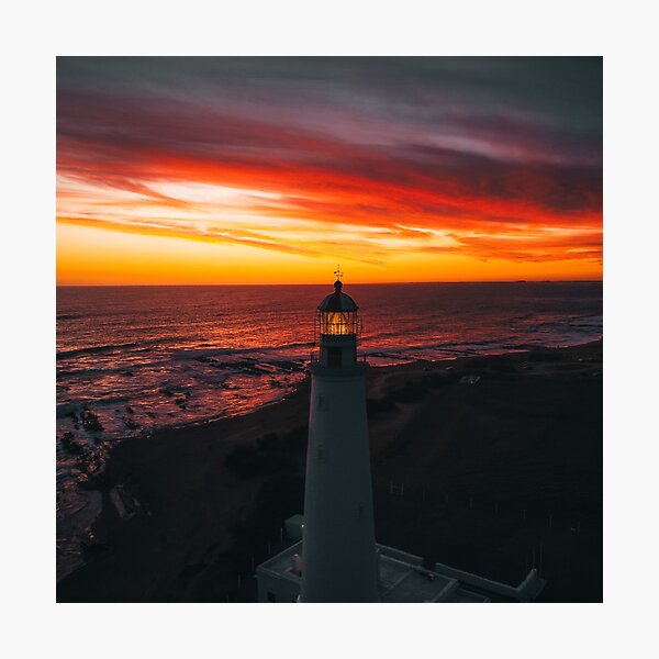 Item preview, Lighthouse On A Sunset Lit Shore designed and sold by Taceo10.
