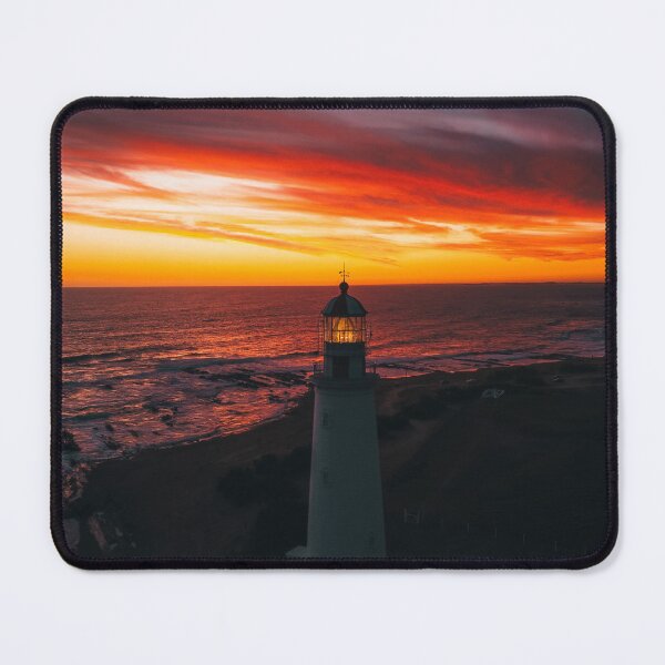 Item preview, Lighthouse On A Sunset Lit Shore designed and sold by Taceo10.