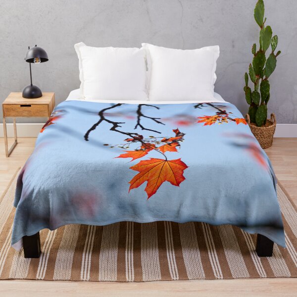 Item preview, Autumnal Leaves clinging on to the tree, against a blue sky designed and sold by CyaniRose.