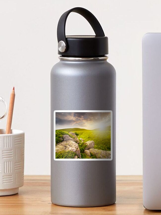 Thumbnail 1 of 3, Sticker, stones in valley on top of mountain range at sunset designed and sold by mike-pellinni.