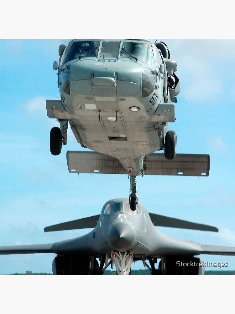 A U.S. Navy MH-60S Seahawk helicopter and a U.S. Air Force B-1B