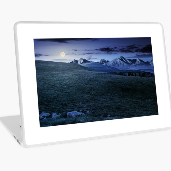 meadow with huge stones on top of mountain range at night Laptop Skin