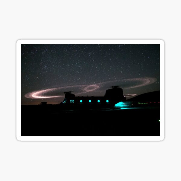 Dust lights up the rotors of a CH-47 Chinook helicopter. Sticker