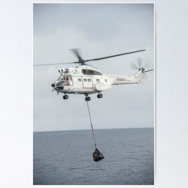 STK107829M-An SA-330 Puma transport helicopter moves cargo during a  vertical Art Board Print