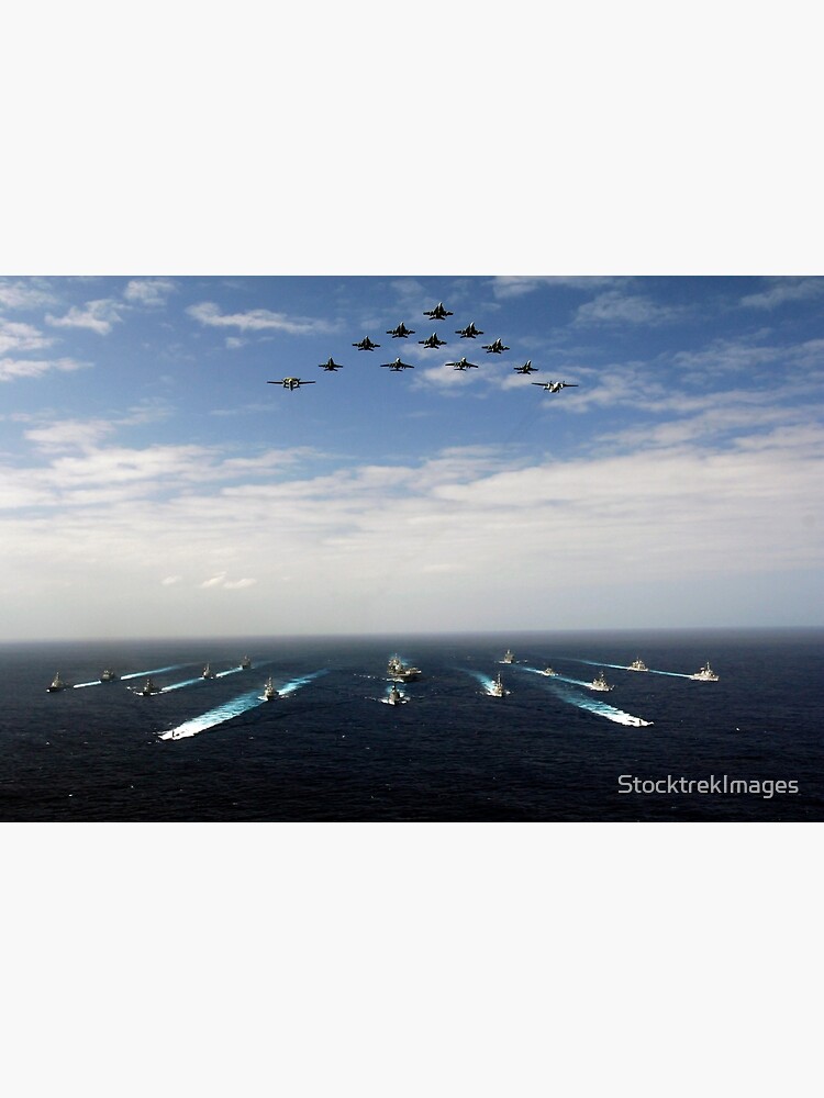 Aircraft fly over a group of U.S. and Japanese Maritime Self-Defense Force ships. by StocktrekImages