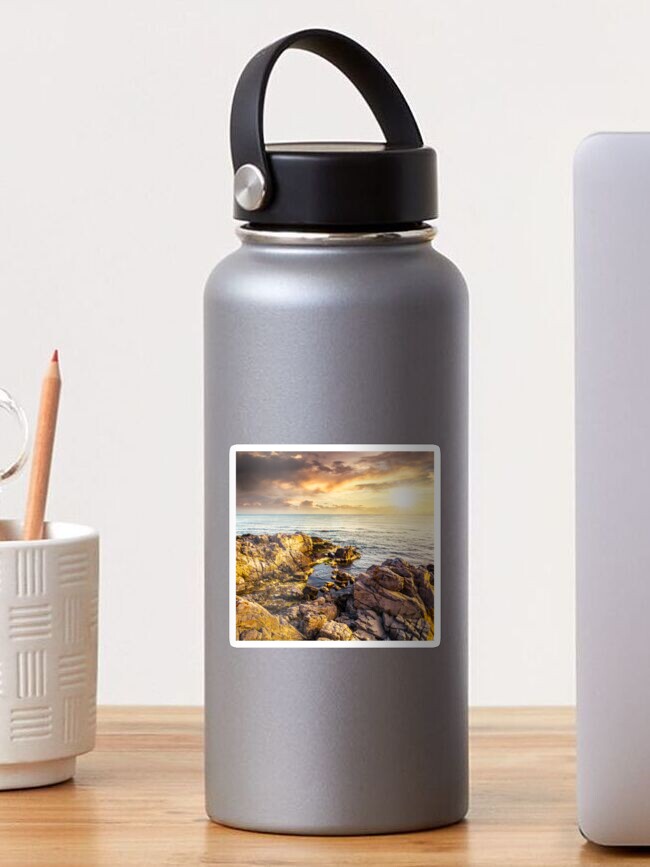 Thumbnail 1 of 3, Sticker, sea landscape on the rocky coast at sunset designed and sold by mike-pellinni.