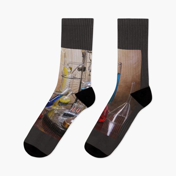 Item preview, Glasses and test tubes of alembic with nixie valves on the wooden table with year 2022 designed and sold by Cinzia Murgia.