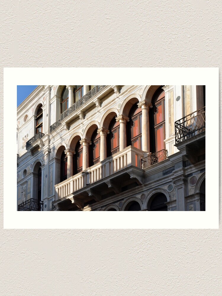 Classical Italian marble building facade with columns arches and