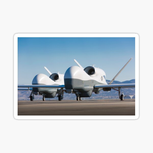 Two MQ-4C Triton unmanned aerial vehicles on the tarmac. Sticker