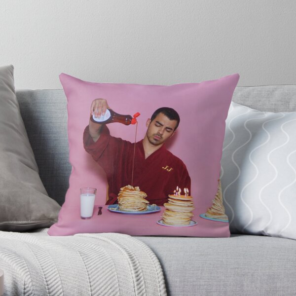 Joe Jonas pouring syrup over some pancakes Throw Pillow
