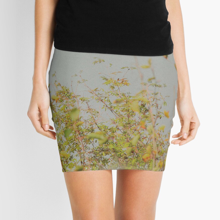 Woman in yellow bushes blurred Mini Skirt