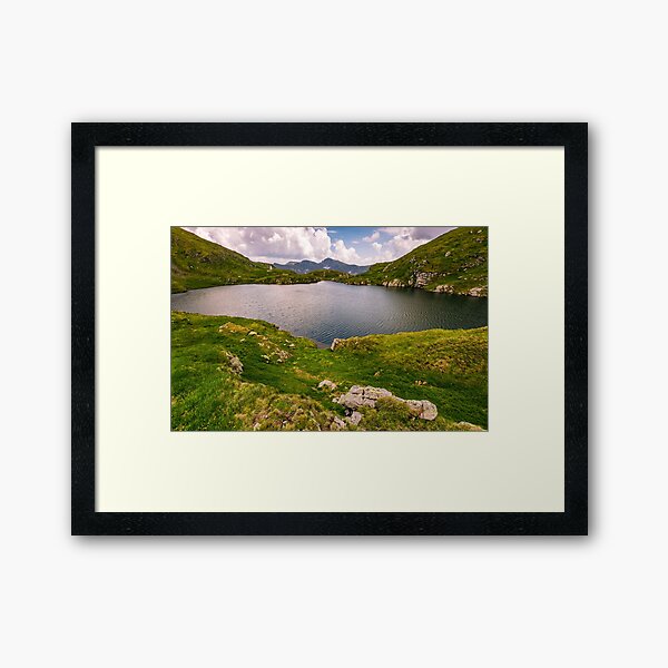 lake in mountains with grass on hillside Framed Art Print