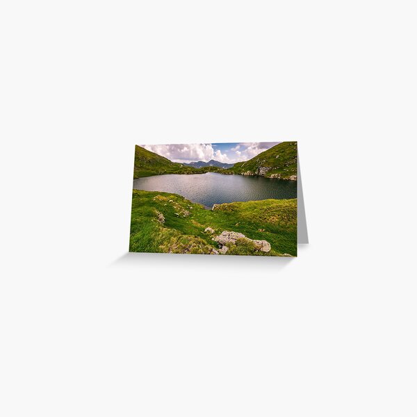 lake in mountains with grass on hillside Greeting Card