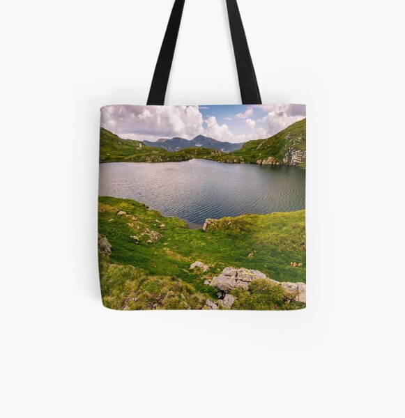 lake in mountains with grass on hillside All Over Print Tote Bag