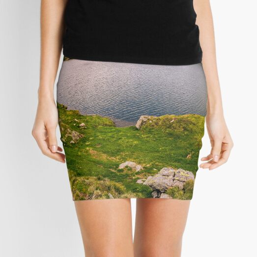 lake in mountains with grass on hillside Mini Skirt