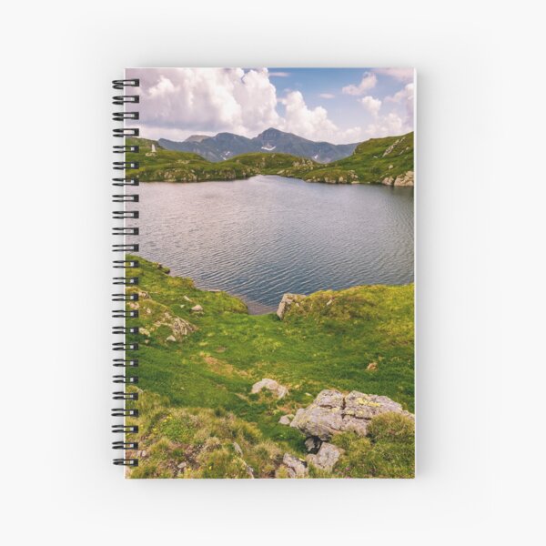 lake in mountains with grass on hillside Spiral Notebook