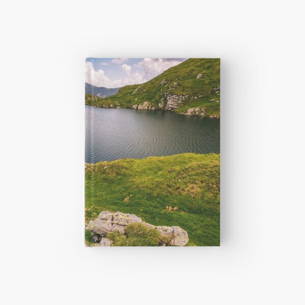 lake in mountains with grass on hillside Hardcover Journal