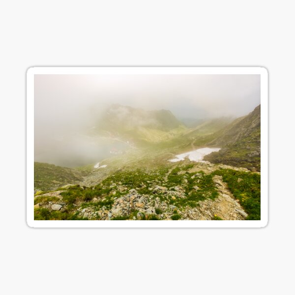 Steep slope on rocky hillside over balea lake in fog Sticker