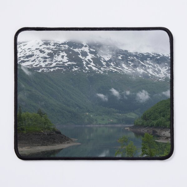 Item preview, Wonderful landscapes in Norway. Vestland. Beautiful scenery of an island in the Roldalsvatnet lake. Snowed mountains and trees on rocks in background. Cloudy day designed and sold by Maurizio Fabbroni.