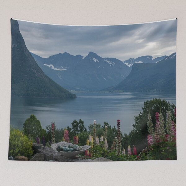 Item preview, Wonderful landscapes in Norway. Vestland. Beautiful scenery of Romsdal Fjord from the Torvikeidet village. Nice flower composition in foreground. Snowed mountains Summer cloudy day designed and sold by Maurizio Fabbroni.