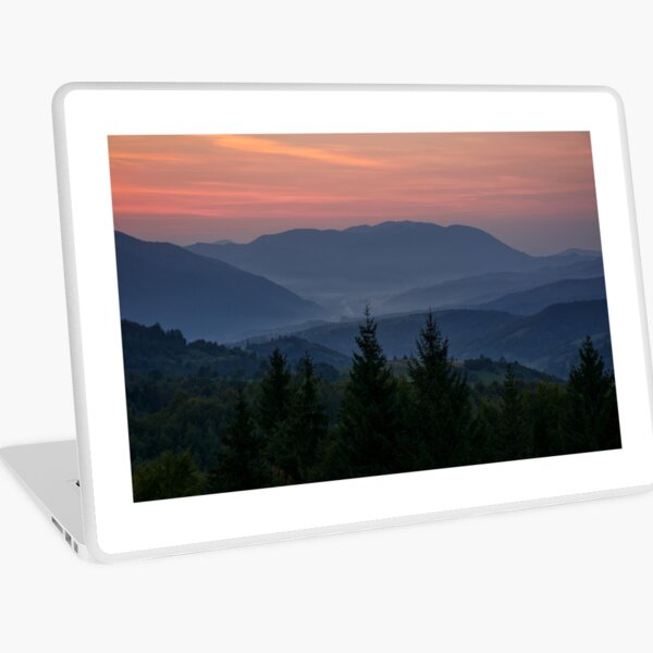 reddish sky at dawn in mountains Laptop Skin