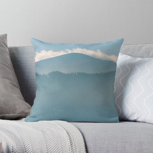 clouds rising behind the blue mountain Throw Pillow