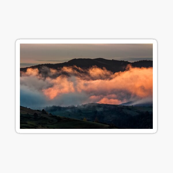 rising clouds in mountainous countryside at sunrise Sticker