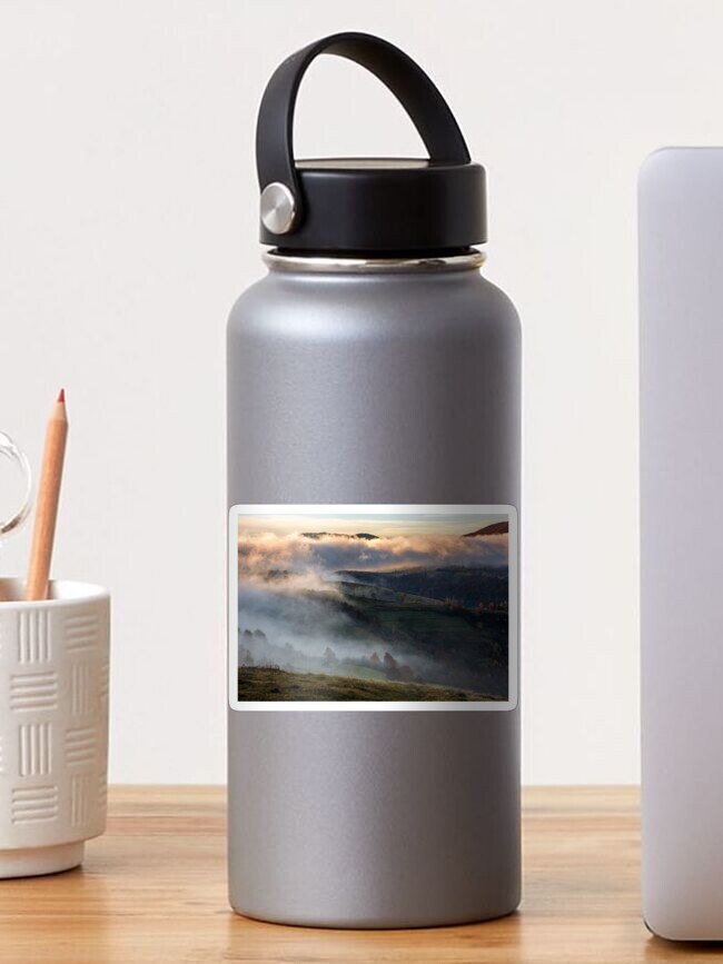 Thumbnail 1 of 3, Sticker, thick fog on hills in countryside at sunrise designed and sold by mike-pellinni.