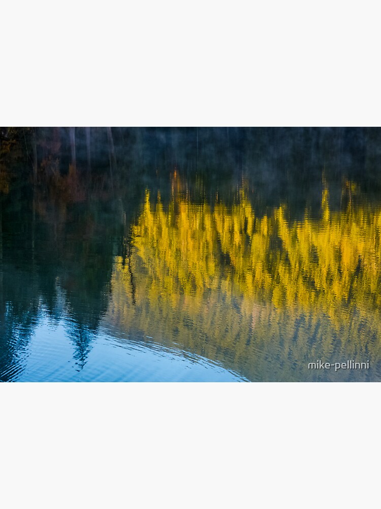 Thumbnail 3 of 3, Sticker, lake surface reflecting spruce forest at sunrise designed and sold by mike-pellinni.