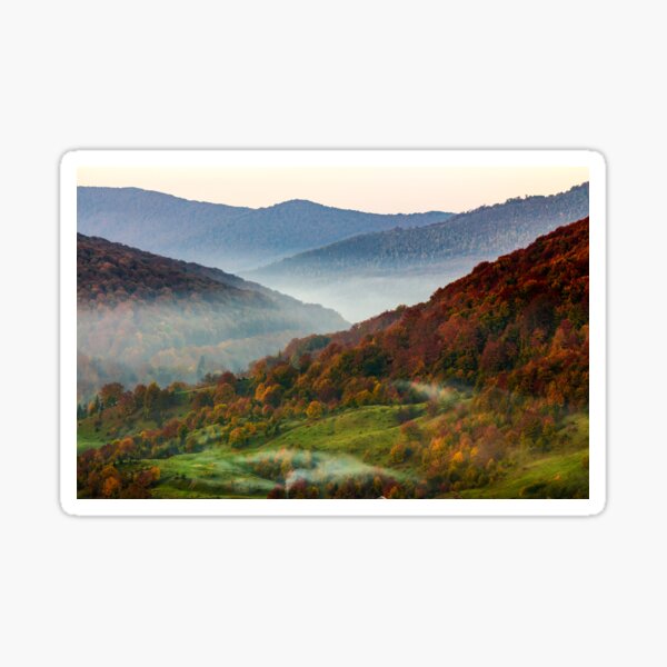 cold fog on hot sunrise in mountains Sticker