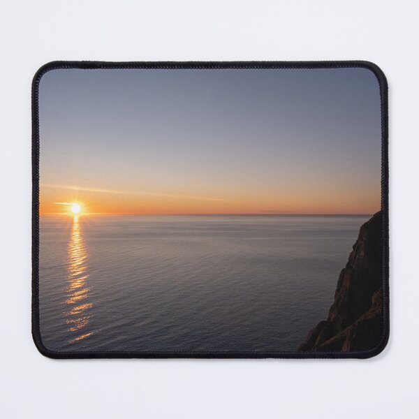 Item preview, Wonderful landscapes in Norway. Nord-Norge. Beautiful scenery of a midnight sun sunset at Nordkapp (Cape North). Boat and globe on a cliff. Rippled sea and clear orange sky. designed and sold by Maurizio Fabbroni.